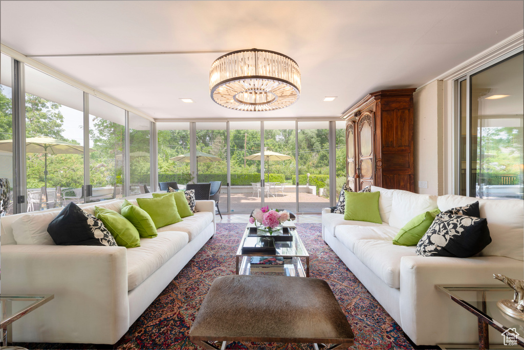 Living room with floor to ceiling windows and a chandelier
