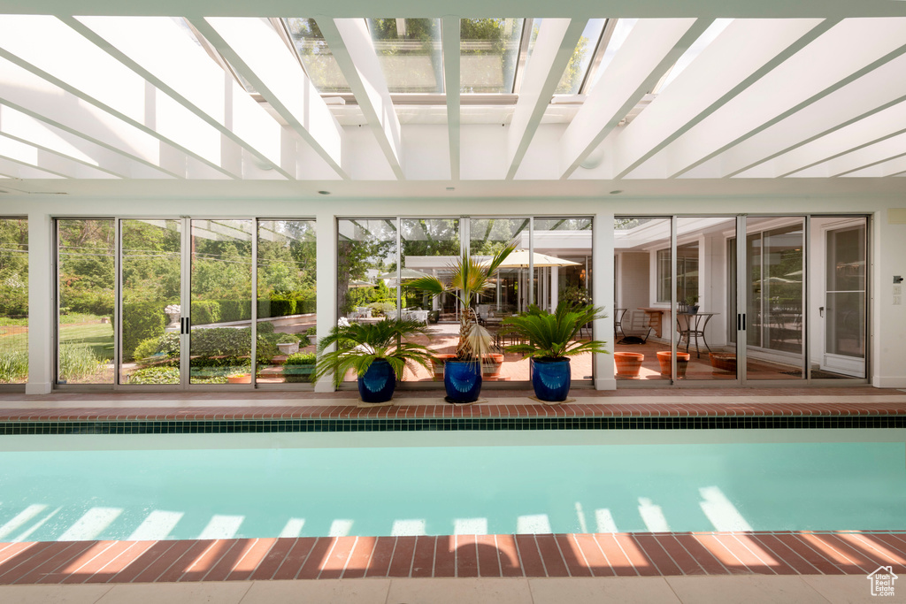 Indoor pool featuring a patio