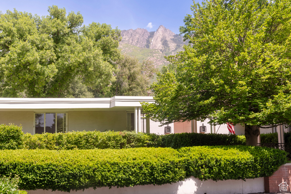View of front of property with stucco siding and a mountain view