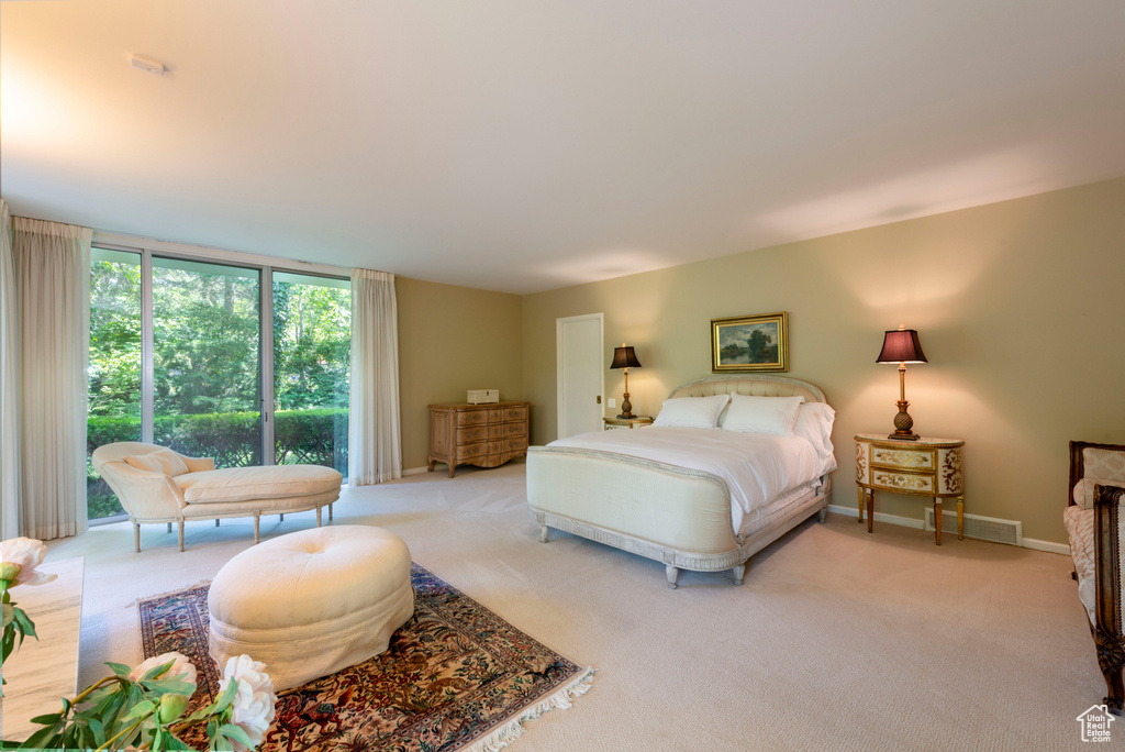 Bedroom featuring light colored carpet and baseboards