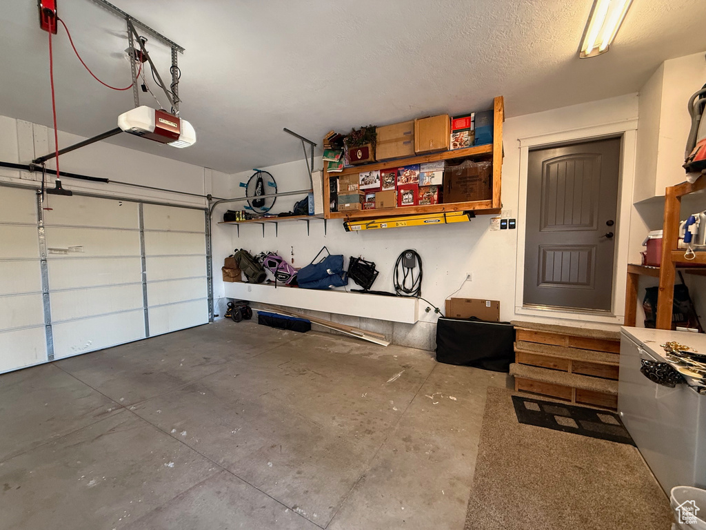 Garage featuring a garage door opener