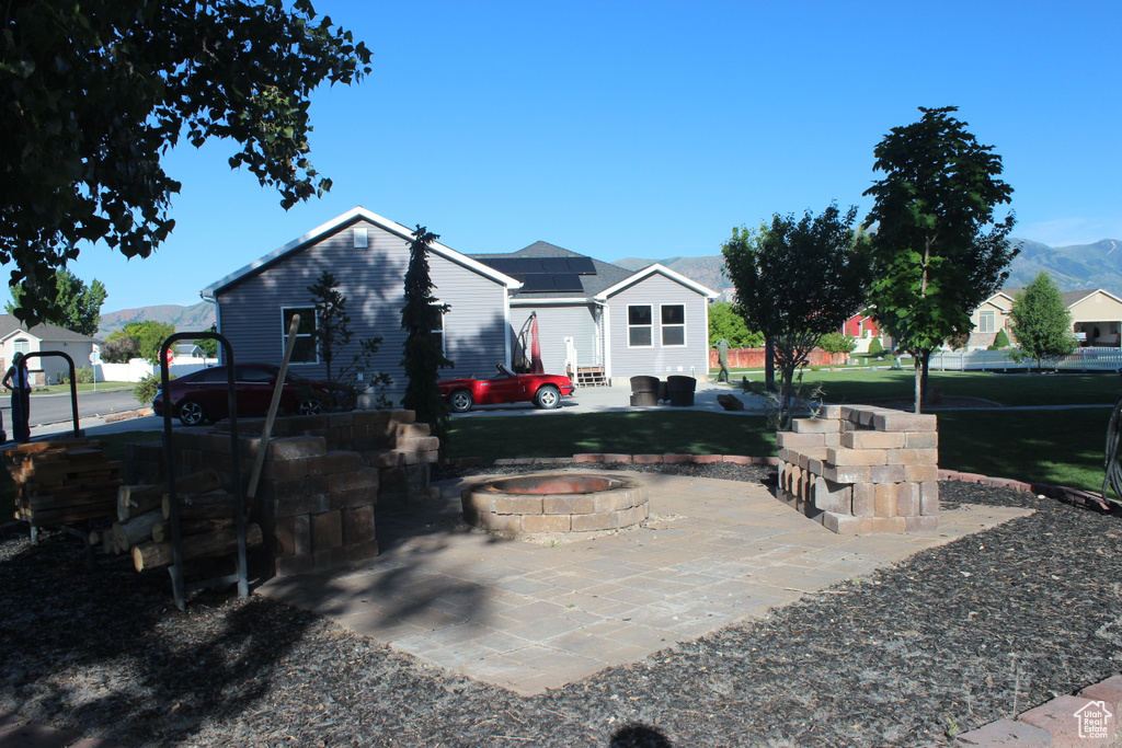 View of yard with a fire pit, a patio area, and a mountain view