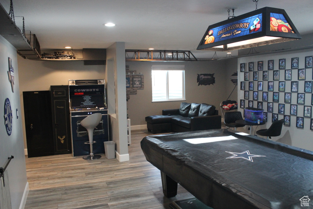 Playroom featuring wood finished floors, baseboards, and recessed lighting
