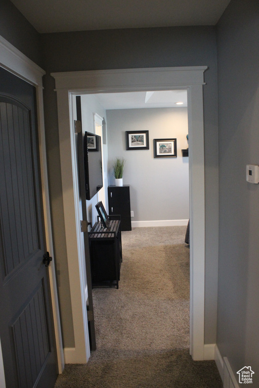 Hall with carpet and baseboards