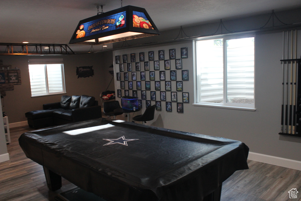 Game room with wood finished floors, baseboards, and billiards