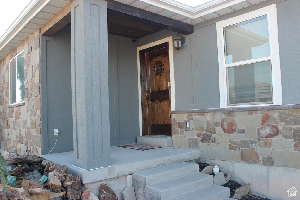 Doorway to property with stone siding