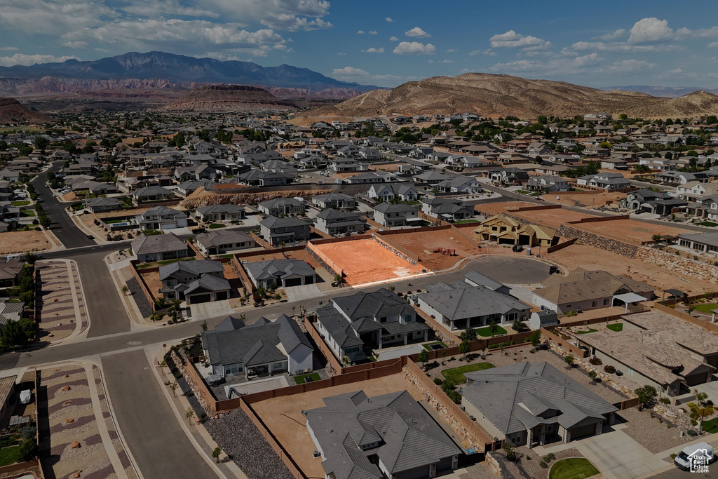 Aerial overview of property\\\'s location with nearby suburban area and a mountainous background