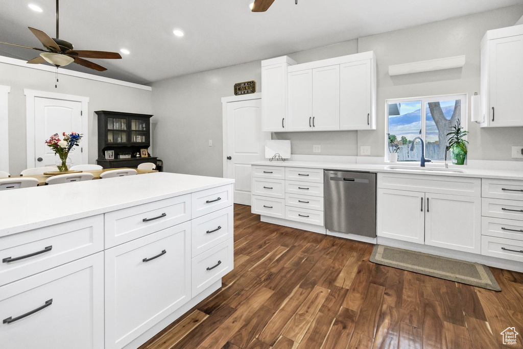 Kitchen with stainless steel dishwasher, a sink, a ceiling fan, dark wood-style floors, and recessed lighting