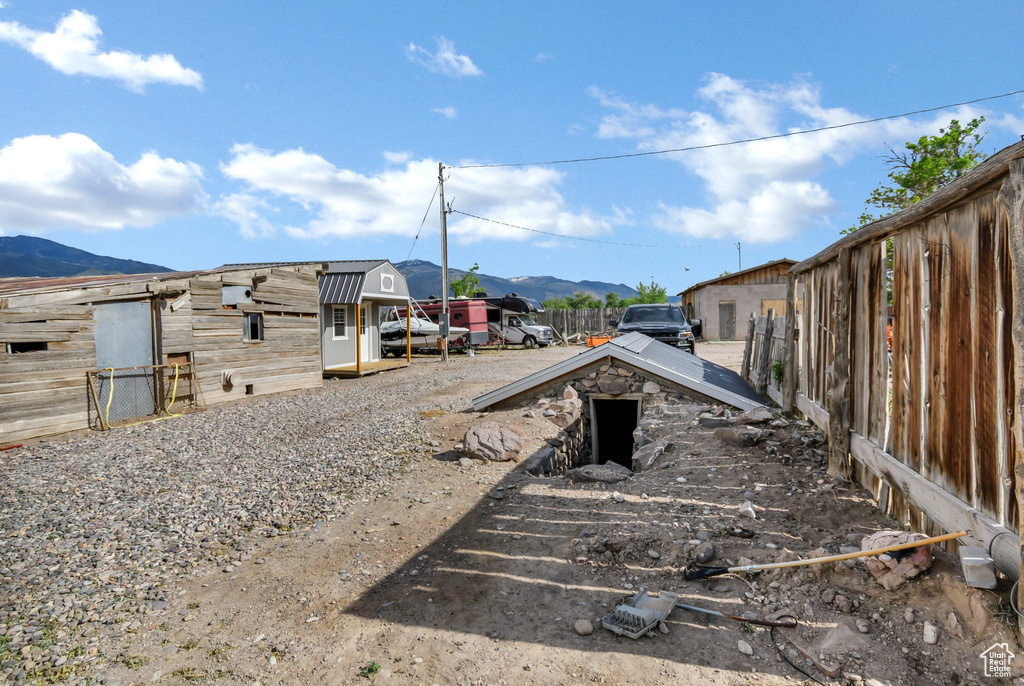 View of yard featuring a mountain view and an outdoor structure