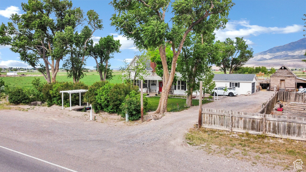 View of front of home with driveway and a mountain view