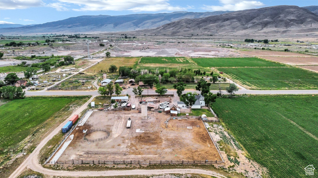 Aerial view of property\\\'s location featuring rural landscape, a mountain backdrop, and large plots for crops