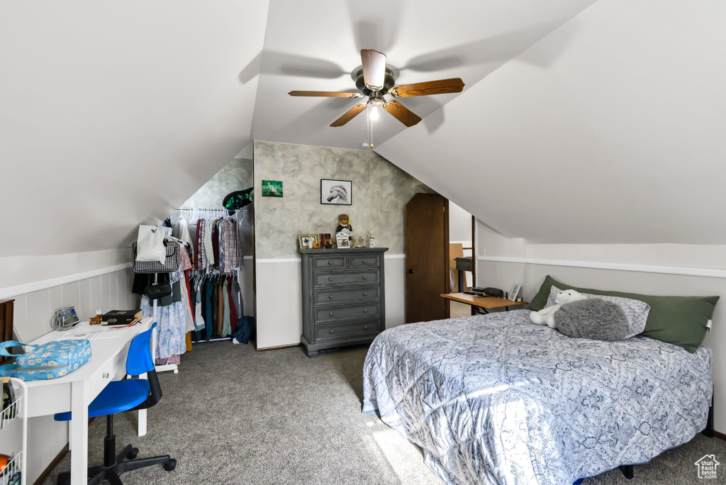 Bedroom with carpet, lofted ceiling, wainscoting, and ceiling fan
