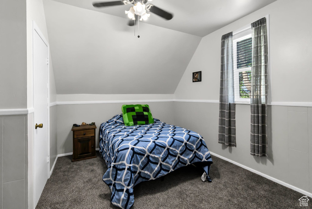 Carpeted bedroom with lofted ceiling and a ceiling fan