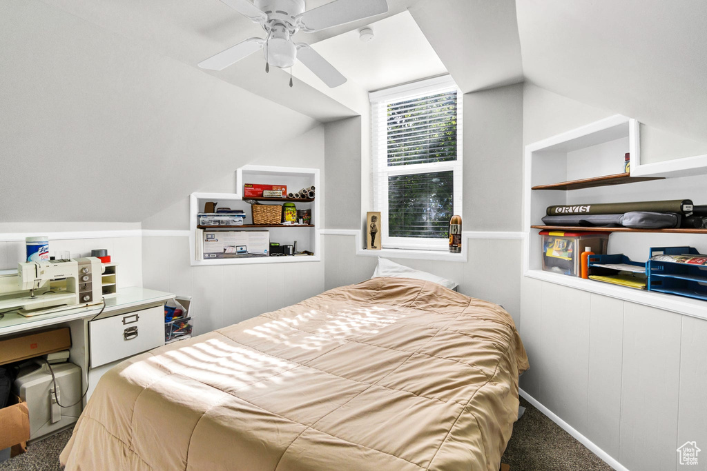 Bedroom featuring carpet floors, lofted ceiling, and a ceiling fan