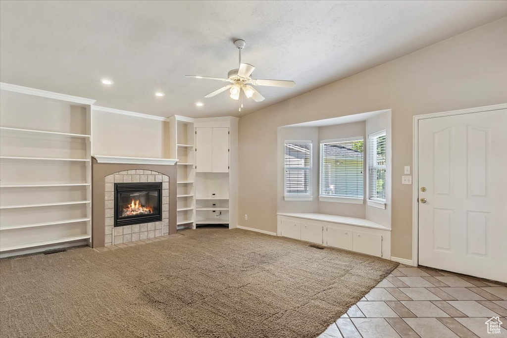 Unfurnished living room featuring recessed lighting, a tile fireplace, a ceiling fan, and baseboards