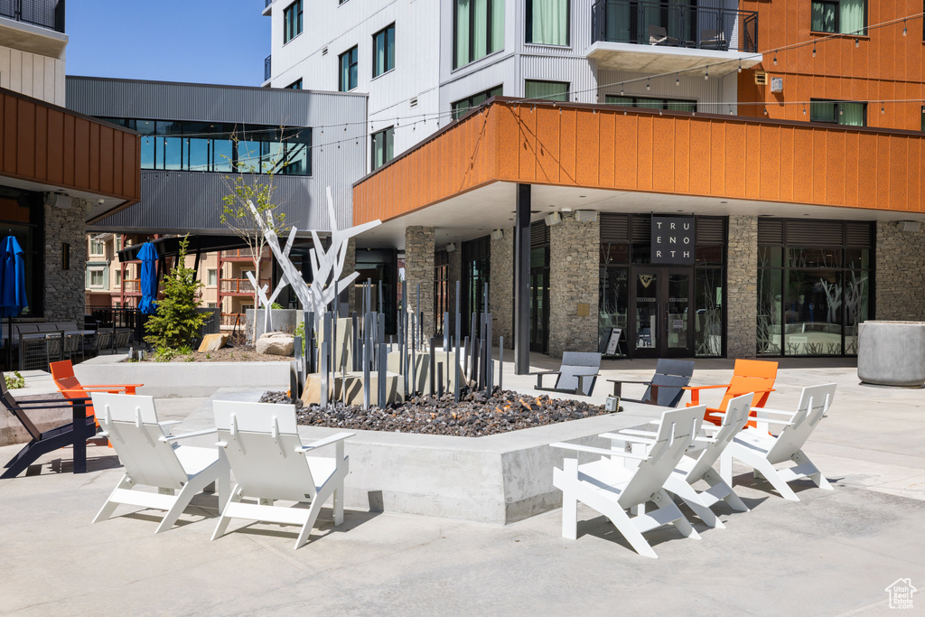 View of patio with a fire pit