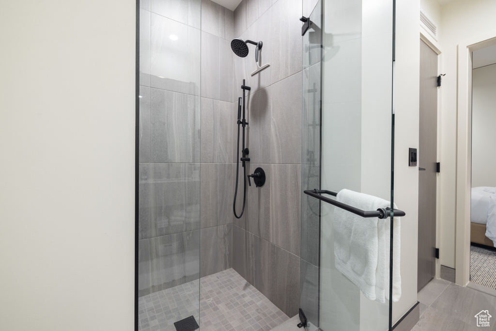 Full bath featuring a stall shower and ensuite bathroom