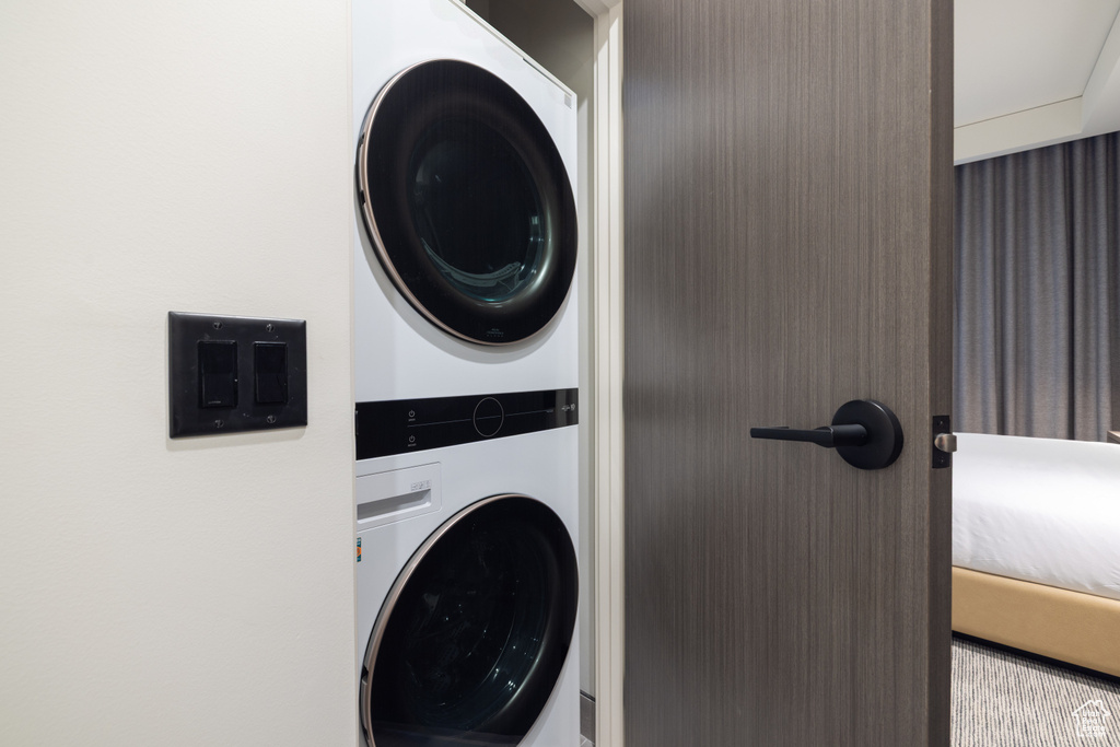 Washroom featuring stacked washer and clothes dryer