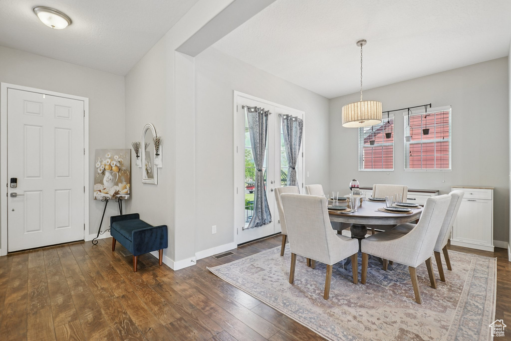Dining space with hardwood / wood-style floors and baseboards