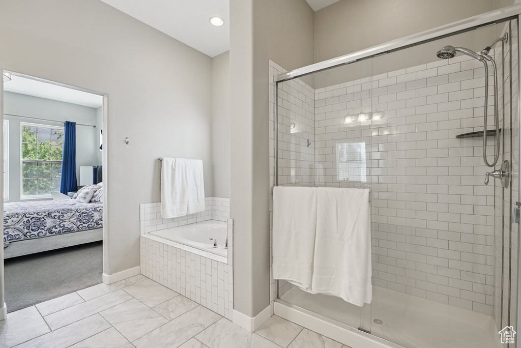 Full bath with a stall shower, connected bathroom, and a garden tub