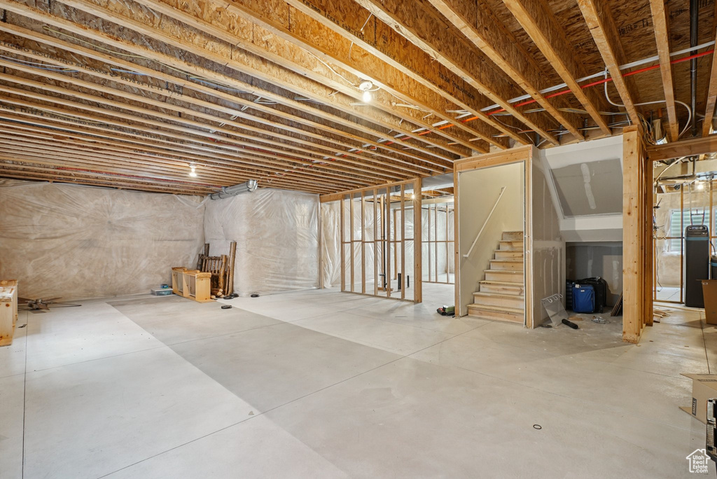 Unfinished below grade area featuring stairs