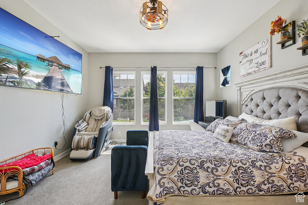 Bedroom featuring carpet and baseboards