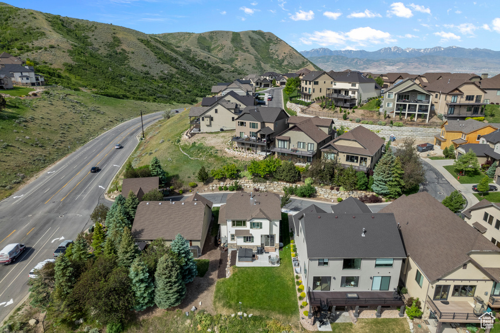Aerial view of property's location with nearby suburban area and mountains