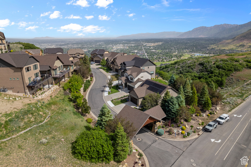 Aerial view of property's location with nearby suburban area and a mountainous background