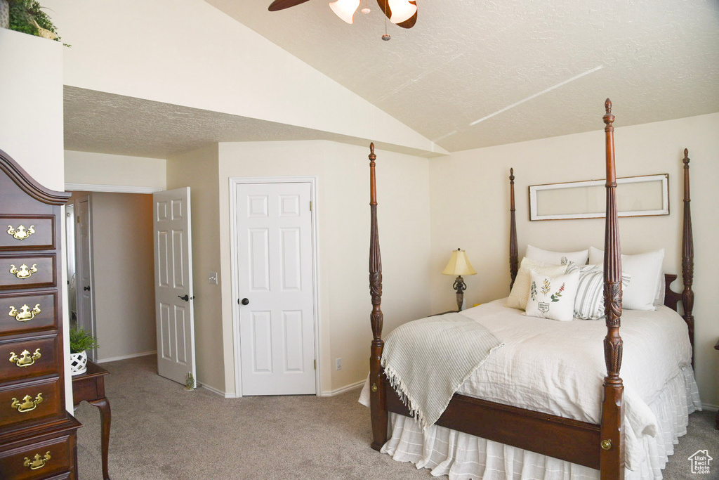 Bedroom featuring carpet, lofted ceiling, baseboards, and a ceiling fan