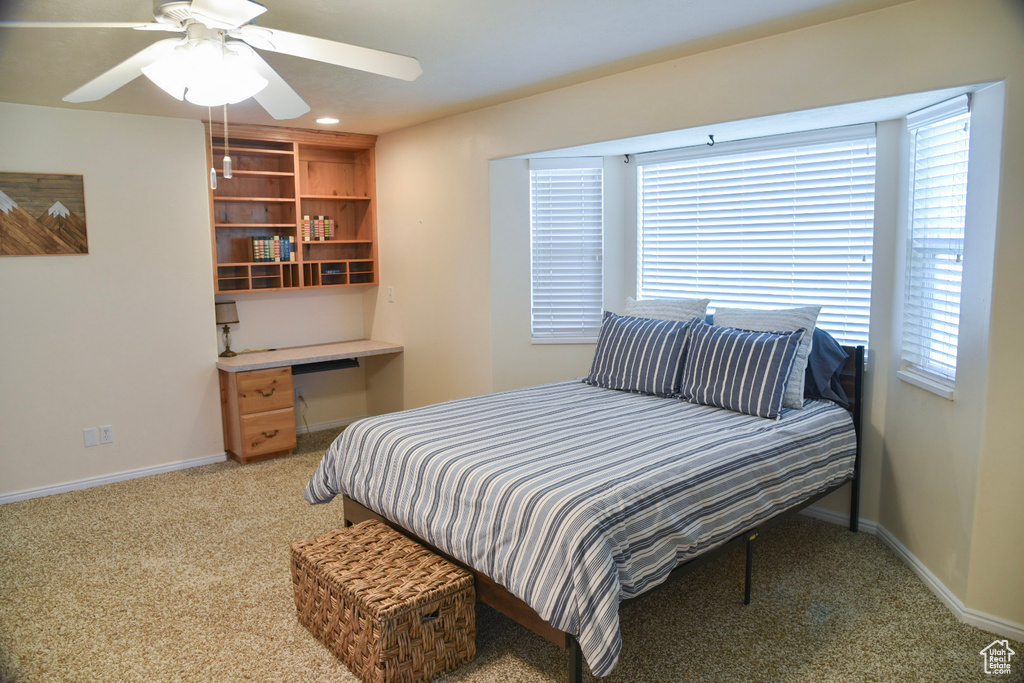 Bedroom with light colored carpet, baseboards, a ceiling fan, and recessed lighting