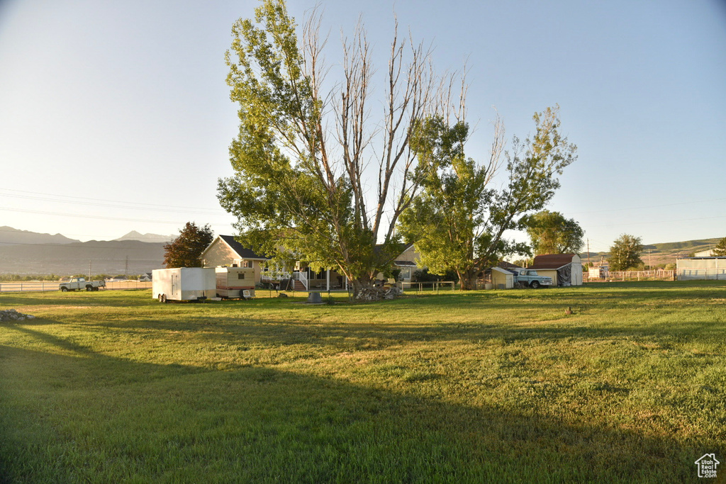 View of grassy yard with a mountain view