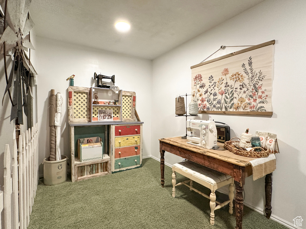 Carpeted office space featuring baseboards