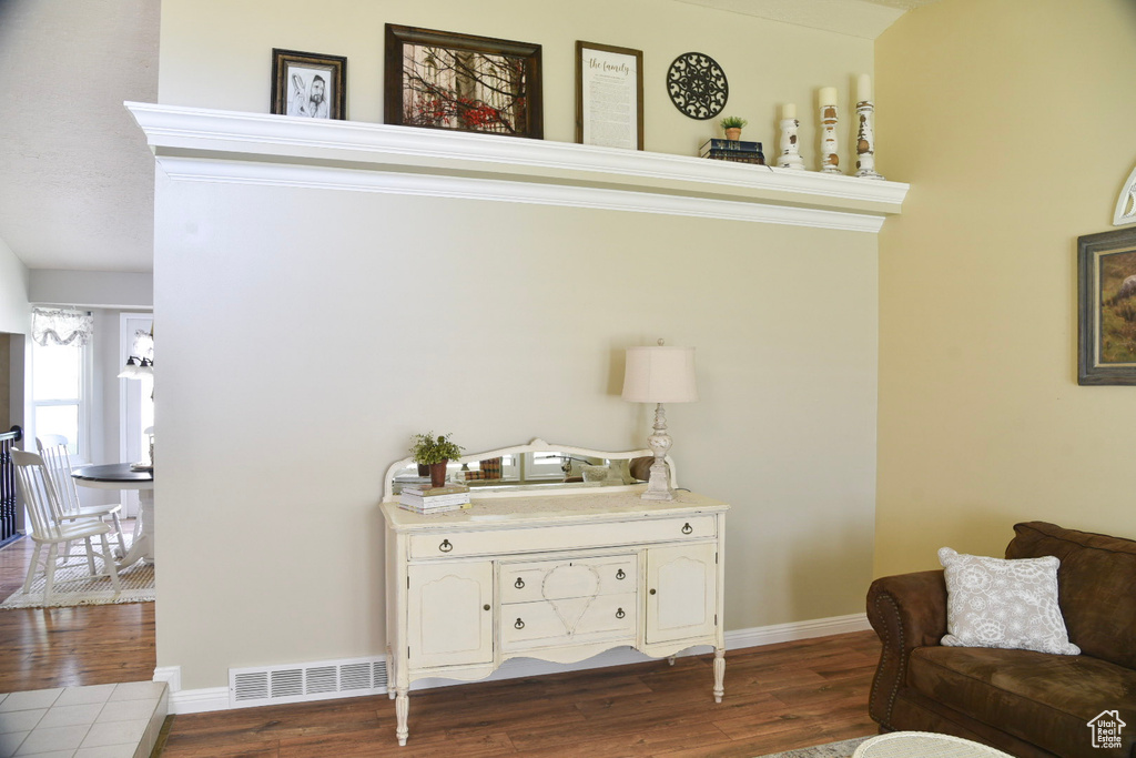 Living area with dark wood-type flooring and baseboards