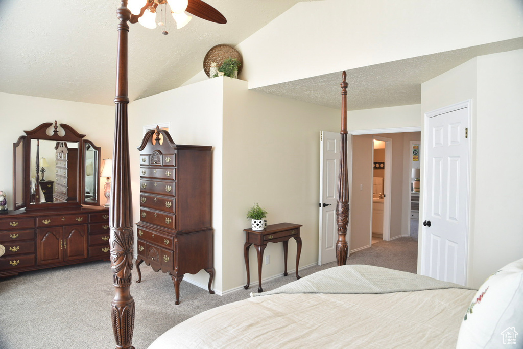 Carpeted bedroom with lofted ceiling, ceiling fan, a textured ceiling, and baseboards