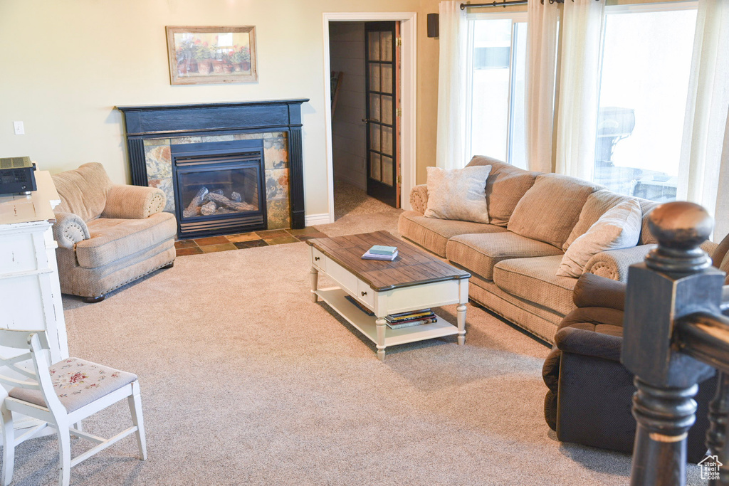 Carpeted living area with a fireplace