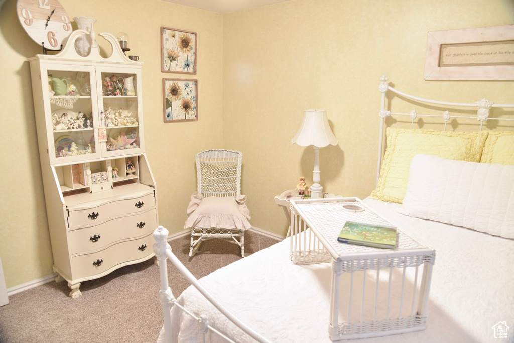 Bedroom featuring carpet and baseboards