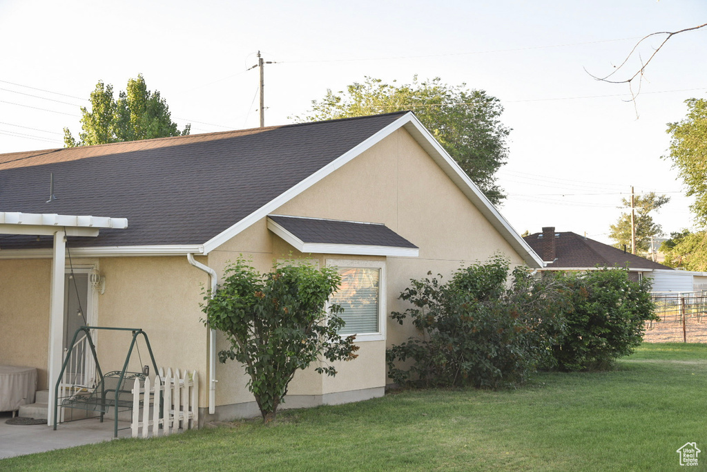 Rear view of property with stucco siding