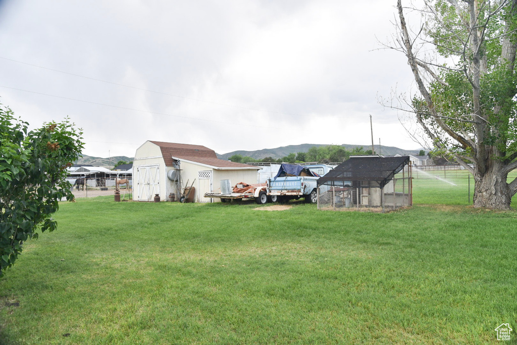 View of yard with an outbuilding, exterior structure, and a mountain view
