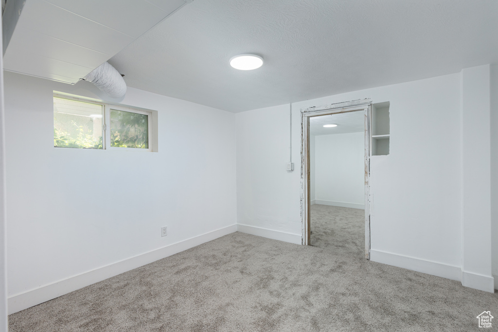 Carpeted spare room with baseboards