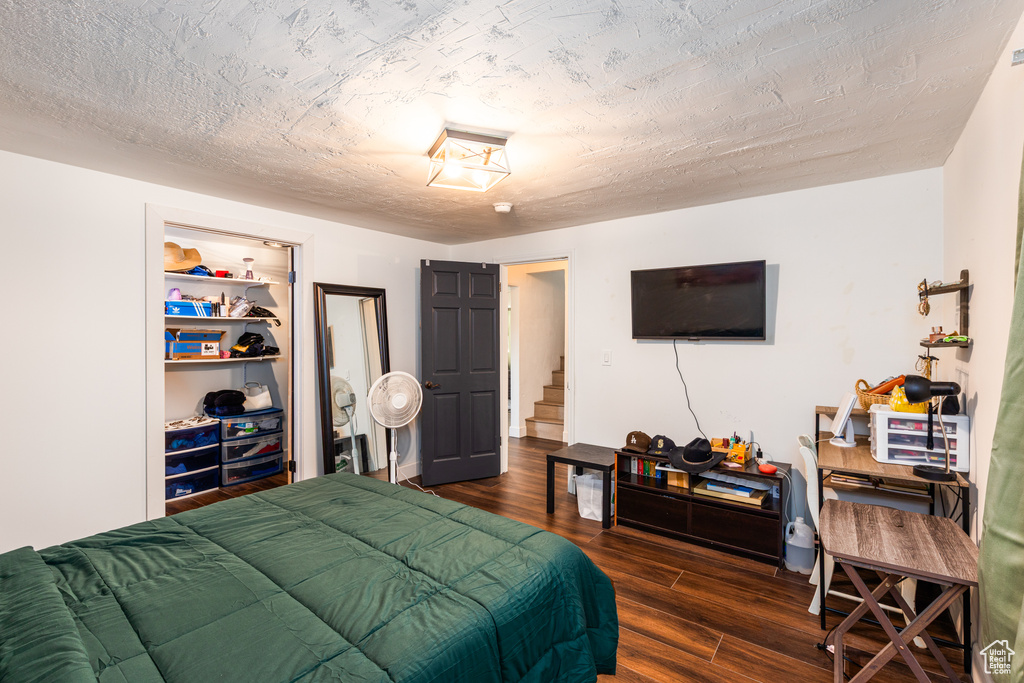 Bedroom featuring dark wood-style flooring