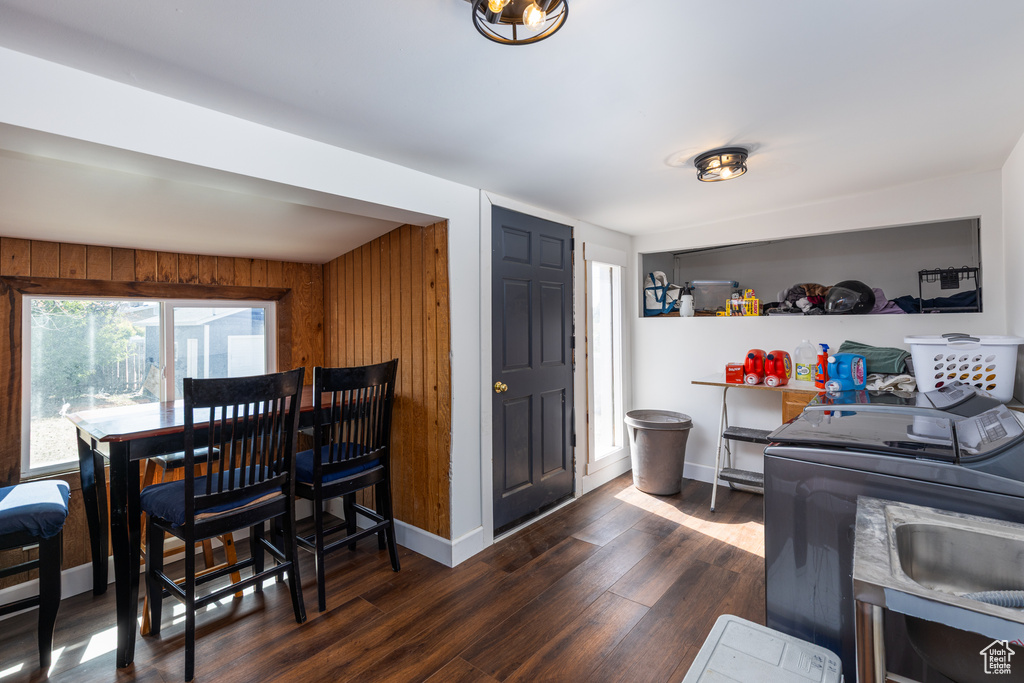Dining room with wood finished floors, baseboards, and washer / dryer