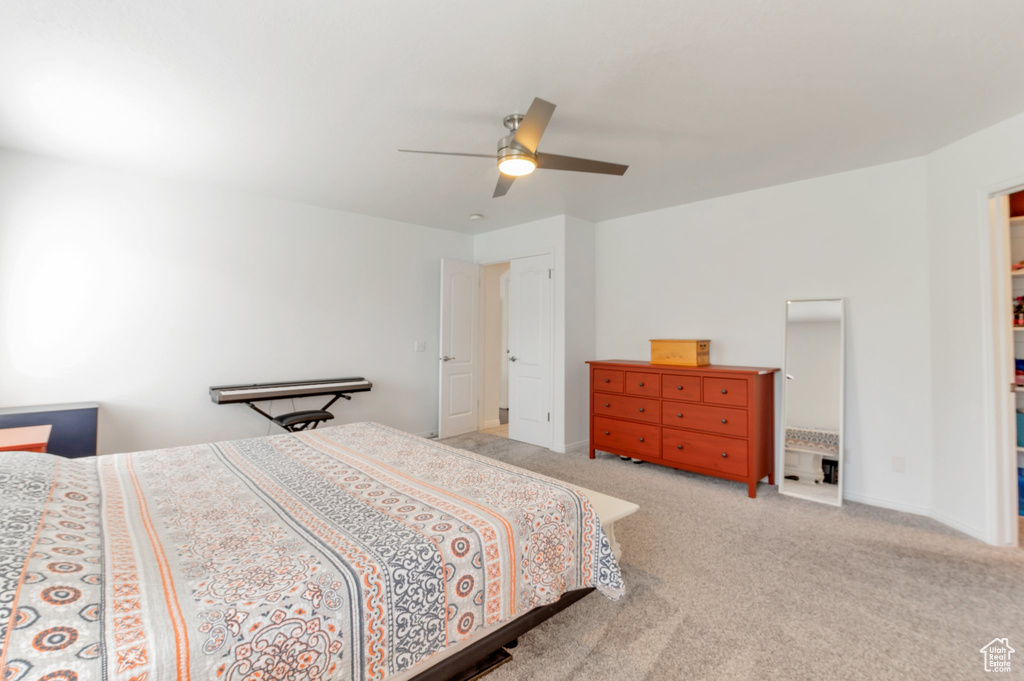 Bedroom with carpet, ceiling fan, and baseboards