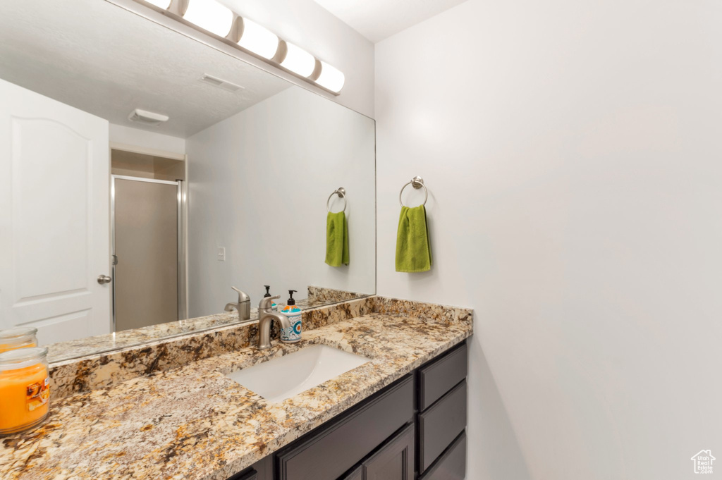 Bathroom with vanity and a stall shower
