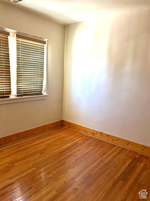 Unfurnished room with baseboards and wood finished floors