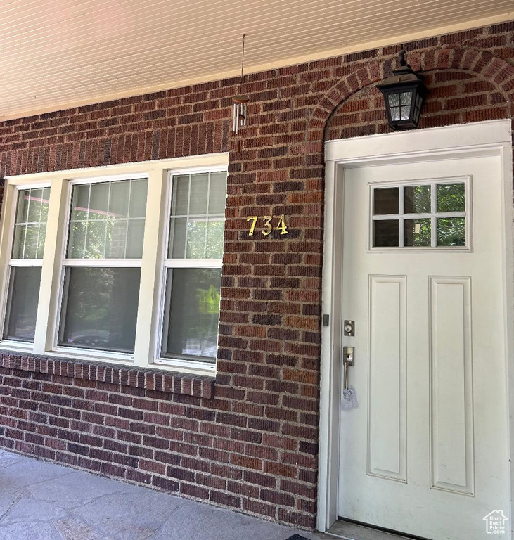 View of exterior entry with brick siding