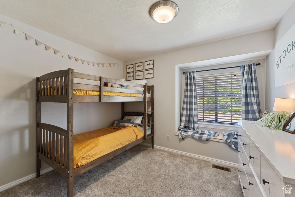Carpeted bedroom with baseboards