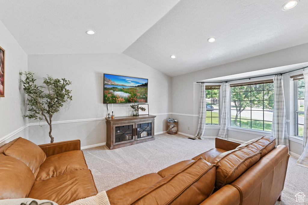 Living area featuring carpet flooring, vaulted ceiling, baseboards, and recessed lighting