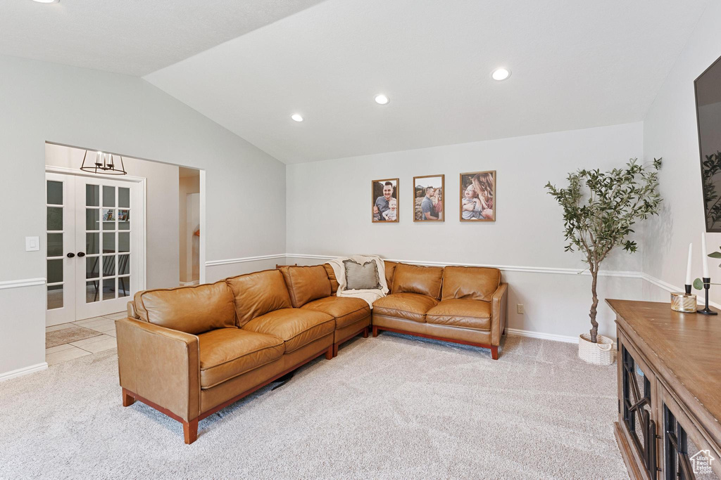 Living area featuring light carpet, lofted ceiling, recessed lighting, french doors, and baseboards