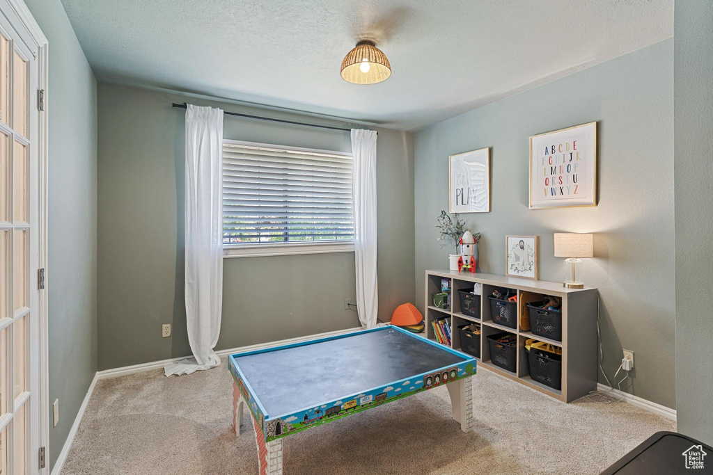 Game room with carpet and baseboards