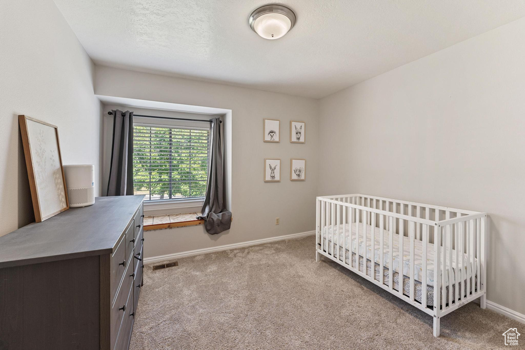 Carpeted bedroom featuring baseboards